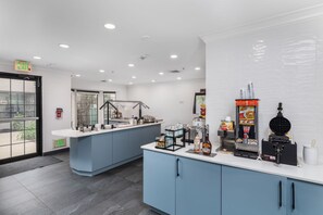 A modern cafe with a counter, seating area, and a view of the outdoors. - Free Breakfast. Pool & Hot Tub. Near East Towne Mall! (Madison)