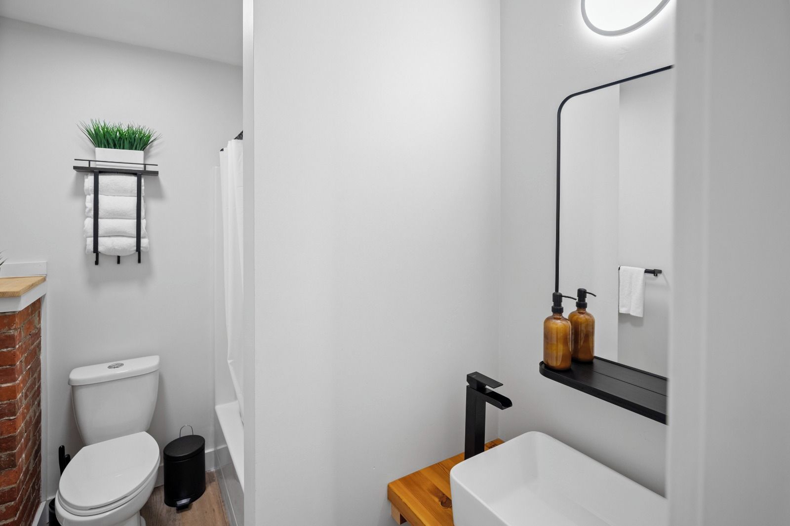 A modern bathroom with a toilet, sink, and shower.