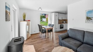 A modern apartment with a dining area, kitchen, and living room. - Lovely home in Süssau/Ostsee with sauna (Süssau/Ostsee)