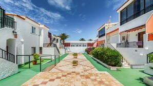 A courtyard with a checkered floor, potted plants, and a clear blue sky. - Vacation Apartment 'Apto Veracruz' with Shared Pool, Private Terrace and Wi-Fi (Costa Adeje)