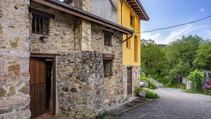 Un edificio de piedra con puerta de madera, pared amarilla y un letrero que dice 'La Cava del Fiume'.