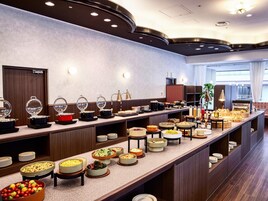 A buffet setup with various food stations and a seating area.