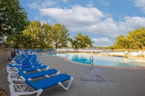 A pool area with blue lounge chairs and a clear sky. - Games, Lake Views, Ease of Access to Unit & Attractions, Family-Friendly, Outdoor Comfort (Lake Ozark)