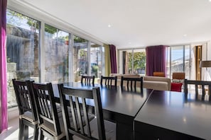 Un espace repas comprenant une grande table, des chaises et un canapé.