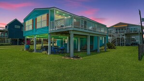 A two-story house with a balcony and a covered patio area. - Escape by the Sea! NEW! (Galveston)