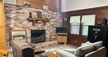 Cozy Cabin setting behind a 1 1/2 acre pond that is lined with Cypress Trees.