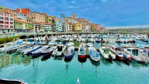 A marina with numerous boats docked, surrounded by colorful buildings. - Aldatseta Home - Apartamento centrico (Bermeo)