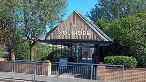 A building with a sign reading "SOUTHSIDE" and a covered entrance. - Sleeps 6, Pets Allowed & Free Parking (Weymouth)