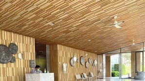 A spacious lobby with a wooden ceiling, marble flooring, and a reception desk. - Family Suite Sea view 2Bedroom  (Pattaya)