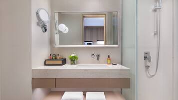 Bathroom features a sink, shower, and towel rack.