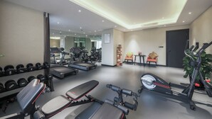 A gym with treadmills, dumbbells, benches, and a stationary bike. - Rezen Dong Hotel Chengdu Tianfu Plaza Store (Chengdu)