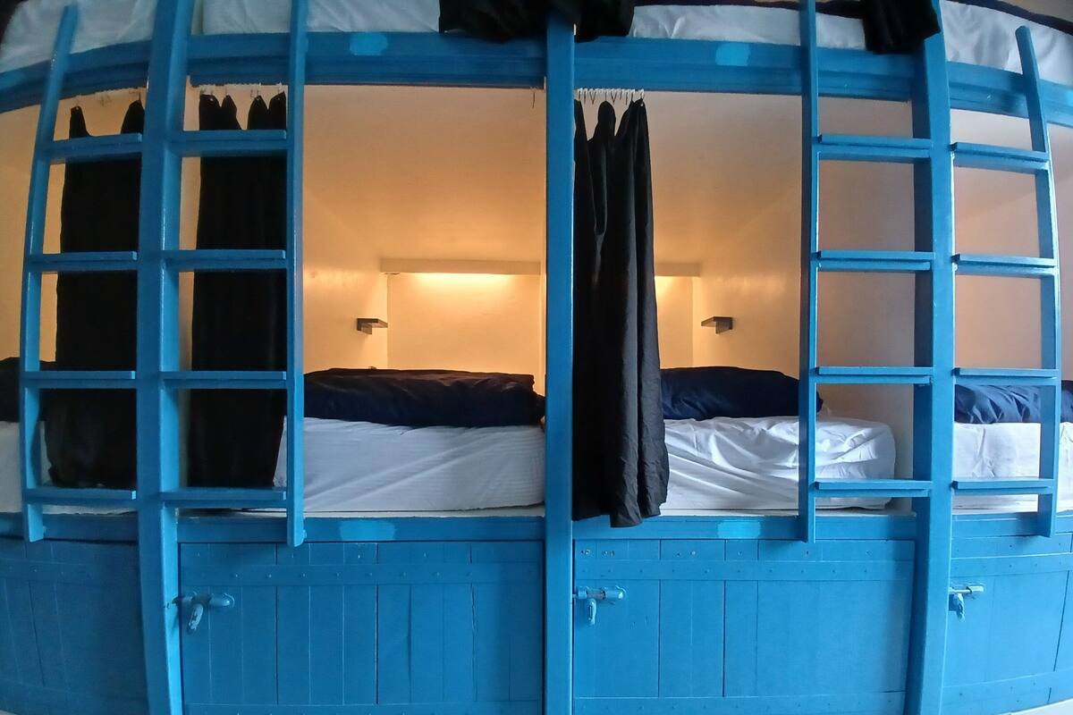 A bunk bed room with a blue exterior and white interior.