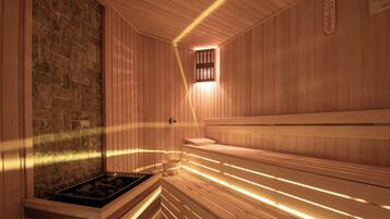 A sauna with wooden benches, a stone wall, and a small window.