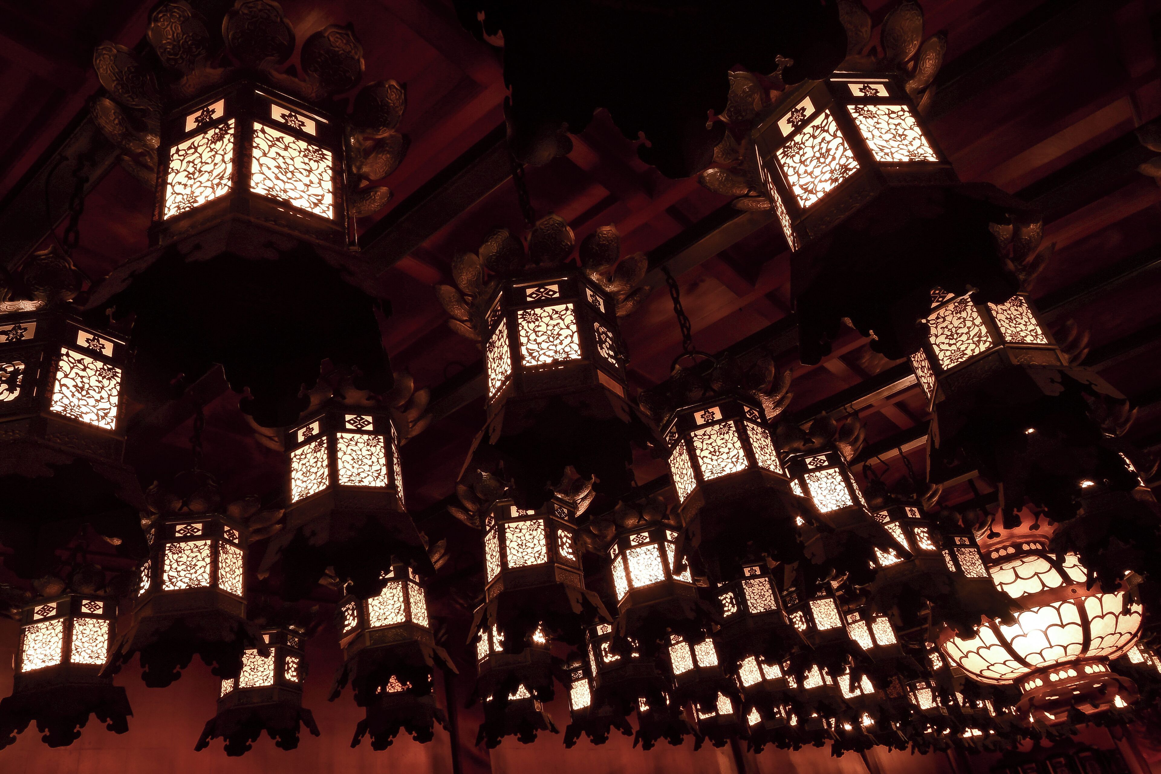 Multiple hanging lanterns with intricate designs.