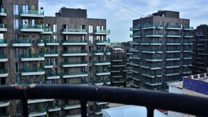 A multi-story residential building with balconies, large windows, and a modern architectural design. - Karvan-N (Tashkent)