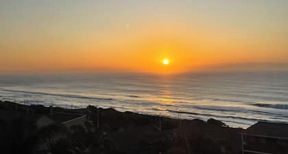 Wake up to gorgeous sunrises and sea views upon a wooden balcony.