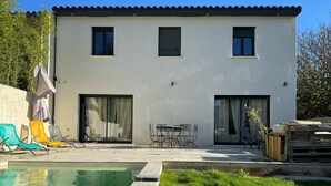 A modern two-story house with a swimming pool, outdoor seating, and a well-maintained lawn. - Superb house with garden and swimming pool close to transport links  (Avignon)
