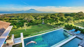A swimming pool with a view of a lush landscape and distant mountains. - 353 Degrees North (Penida Island)