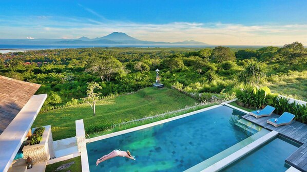 A swimming pool with a view of a lush landscape and distant mountains. - 353 Degrees North (Penida Island)