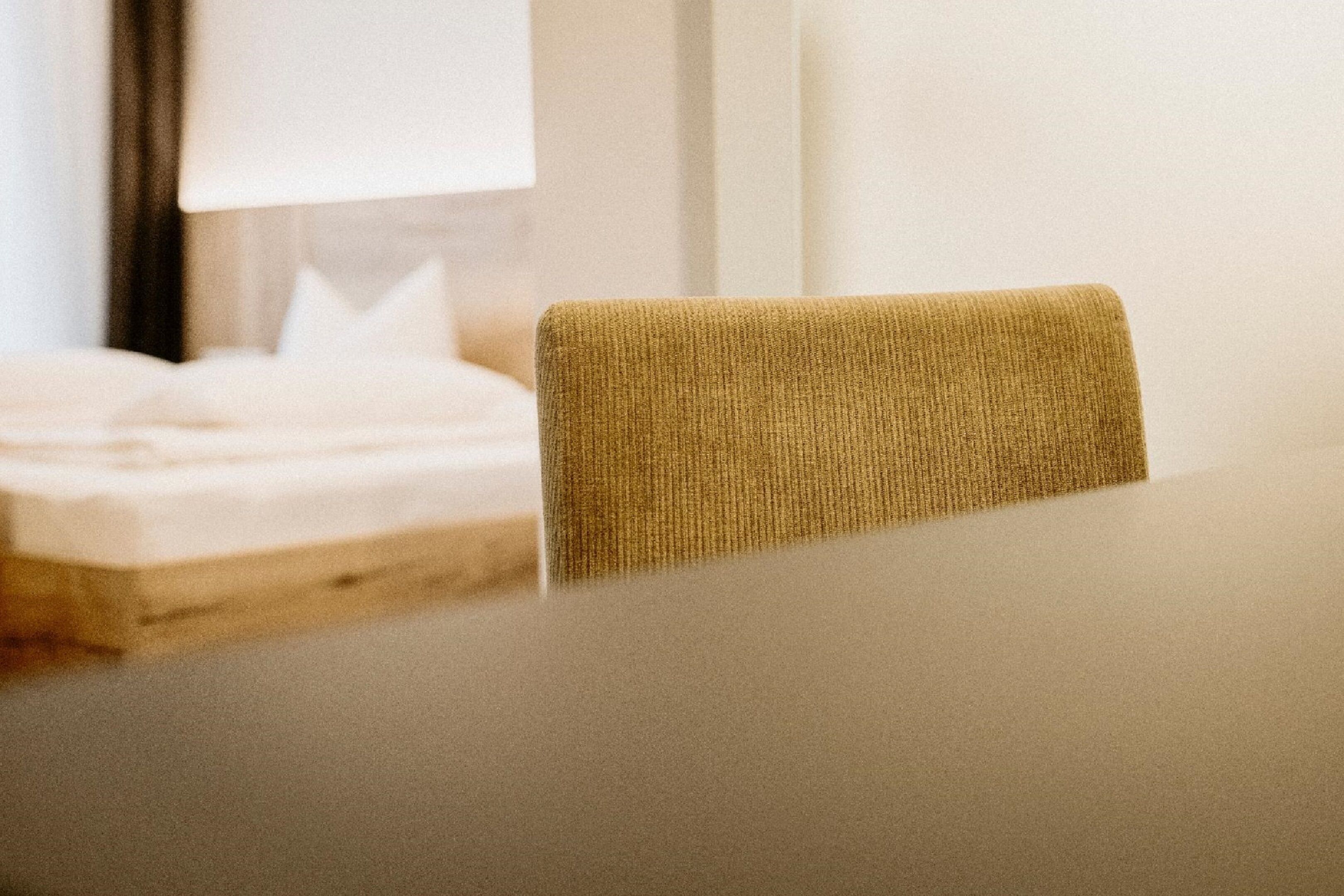 A room with a bed, a table, and a chair.