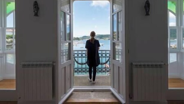 A view from a room with a balcony, looking out to a body of water and distant land. - "Apartamentos Bestarruza" - 2 rooms (Mugardos)
