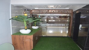 A reception area with a sign reading "GREEN FORTUNE HOTEL RECEPTION". - Hotel Green Fortune (Ahmedabad)