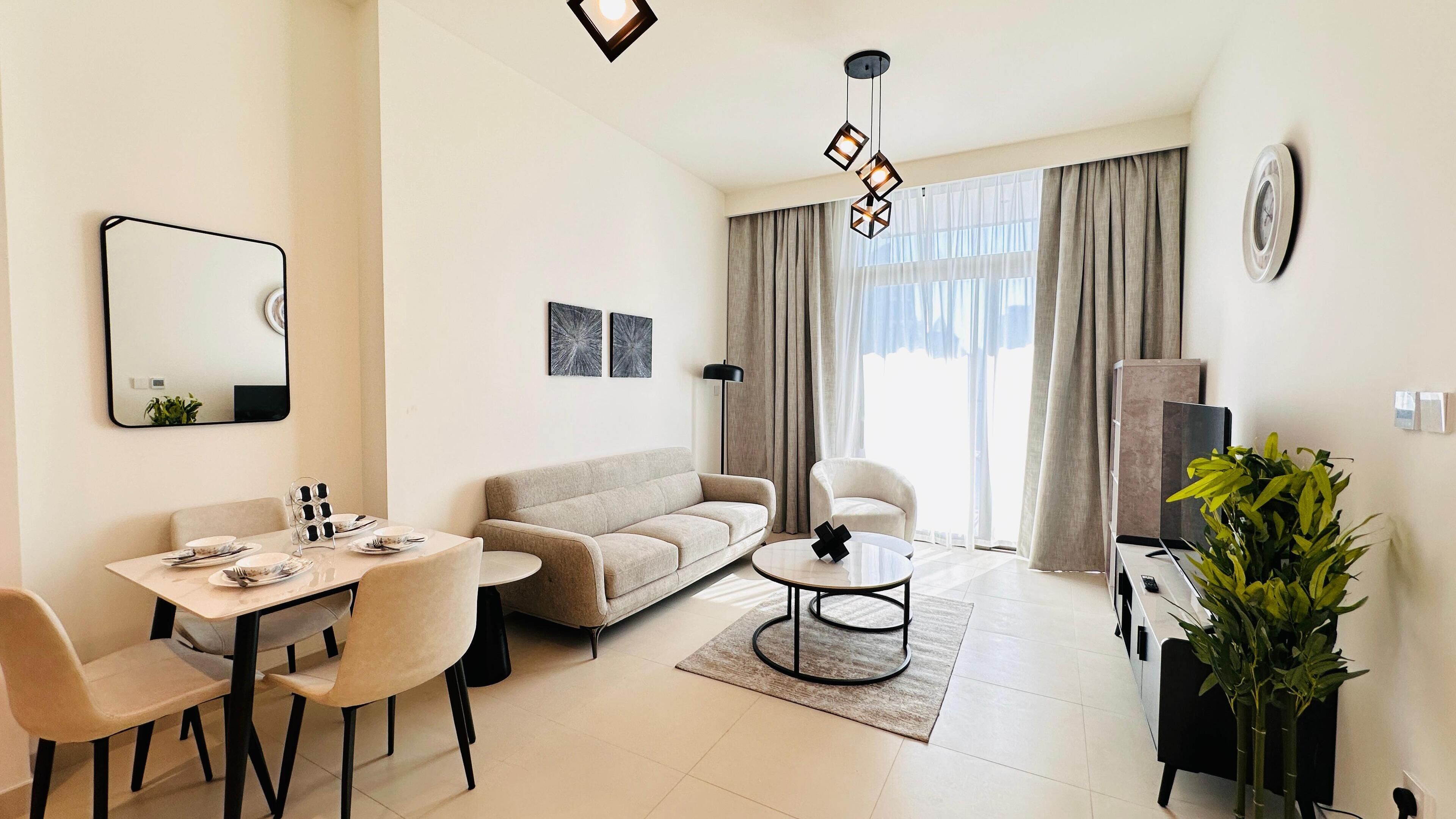 A modern living room with a sofa, dining table, chairs, a coffee table, a TV, and a large window with curtains.