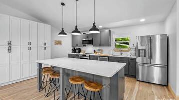 Fridge, stovetop, dishwasher, coffee/tea maker