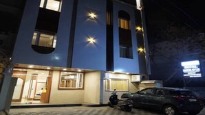A two-story building with a blue facade, multiple windows, and a sign indicating it is a hotel. - Hotel Rudravue (Indore)
