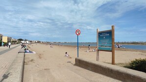 A beach with a sign indicating 'Welcome to the Beach of Grazel'.