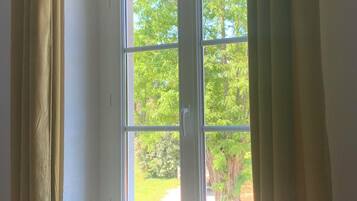Una ventana con vistas a zonas verdes.