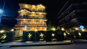 A multi-story building with a prominent entrance and a sign indicating it is a new solitary lodge. - Hotel Vibe (Pokhara)