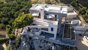 A modern multi-story building with a rooftop terrace, outdoor seating, and a staircase leading to the upper levels. - Deluxe apartment Noeli (Krvavica)