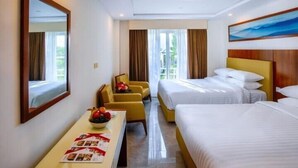 A hotel room with two beds, a desk with a fruit bowl, and a large window with curtains. - Avari Xpress Skardu (Skardu)