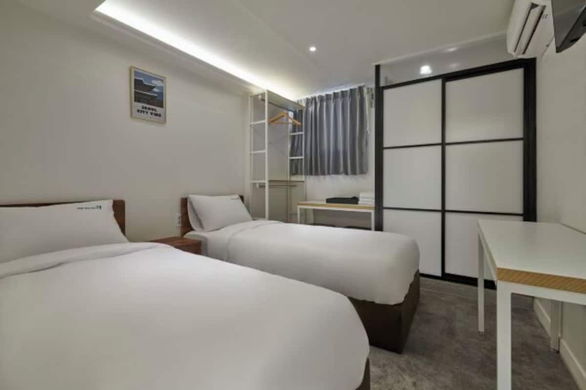 Premium bedding, memory-foam beds, desk, laptop workspace