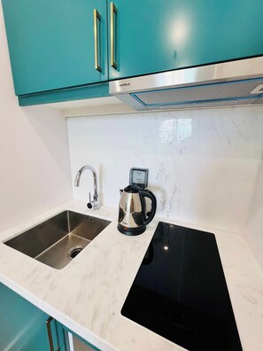 Minikjøleskap, kjøkkenutstyr, miljøvennlige rengjøringsmidler og fryser