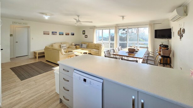 A spacious living area with a sofa set, a dining table, and a kitchen area with a dishwasher. - 300 Steps - 300 Steps to Robes' famous Longbeach - Pet friendly Inside (Robe)