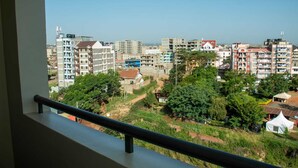 A balcony with a view of a residential area, including multi-story buildings and greenery. - Lux Suites Clay City Heights Kasarani (Nairobi)