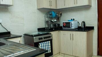 Fridge, microwave, cookware/dishes/utensils, dining tables