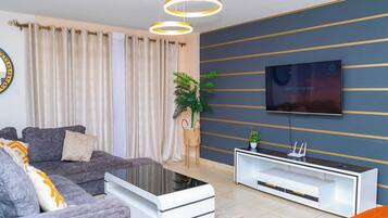 Business Apartment | Living area | 24-inch Smart TV with digital channels