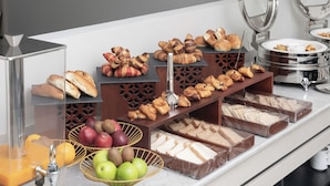 A buffet with various food items including pastries, sandwiches, and fruits. - Sunway Tabuk Hotel (Tabuk)
