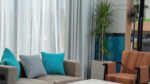 A modern living room with a sofa, armchairs, and a coffee table. - Sunway Tabuk Hotel (Tabuk)