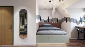 A bedroom with a bed, a mirror, a desk, and a ceiling light fixture. - Mezzotel (Gladbeck)