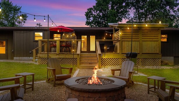 A patio area with a fire pit, outdoor seating, and a covered seating area with string lights. - Becca's Place 3 Bedroom Home by RedAwning (Pigeon Forge)