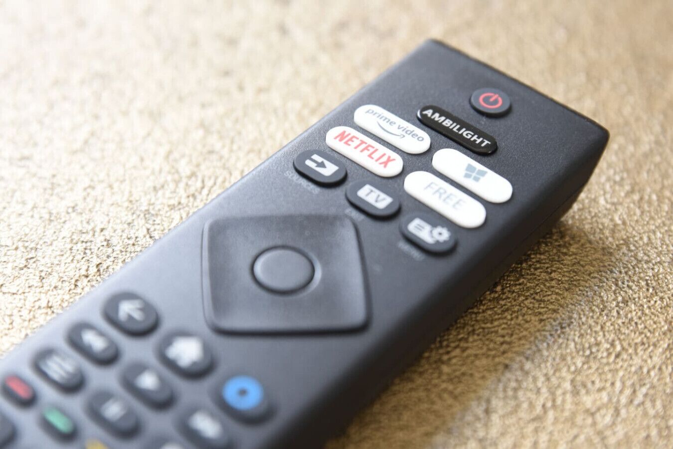 A remote control with buttons for Netflix, TV, and other functions.