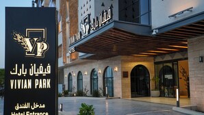 Der Eingang des Vivian Park Hotels mit einem Schild, das den Hotelnamen und die Wegweiserung anzeigt.