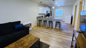 A compact living space with a kitchenette, a dining area, and a seating area.