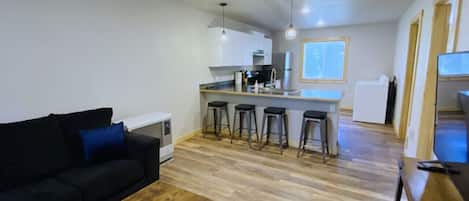 A compact living space with a kitchenette, a dining area, and a seating area.