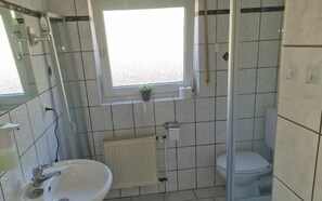 Een douche, een haardroger, een bidet, handdoeken