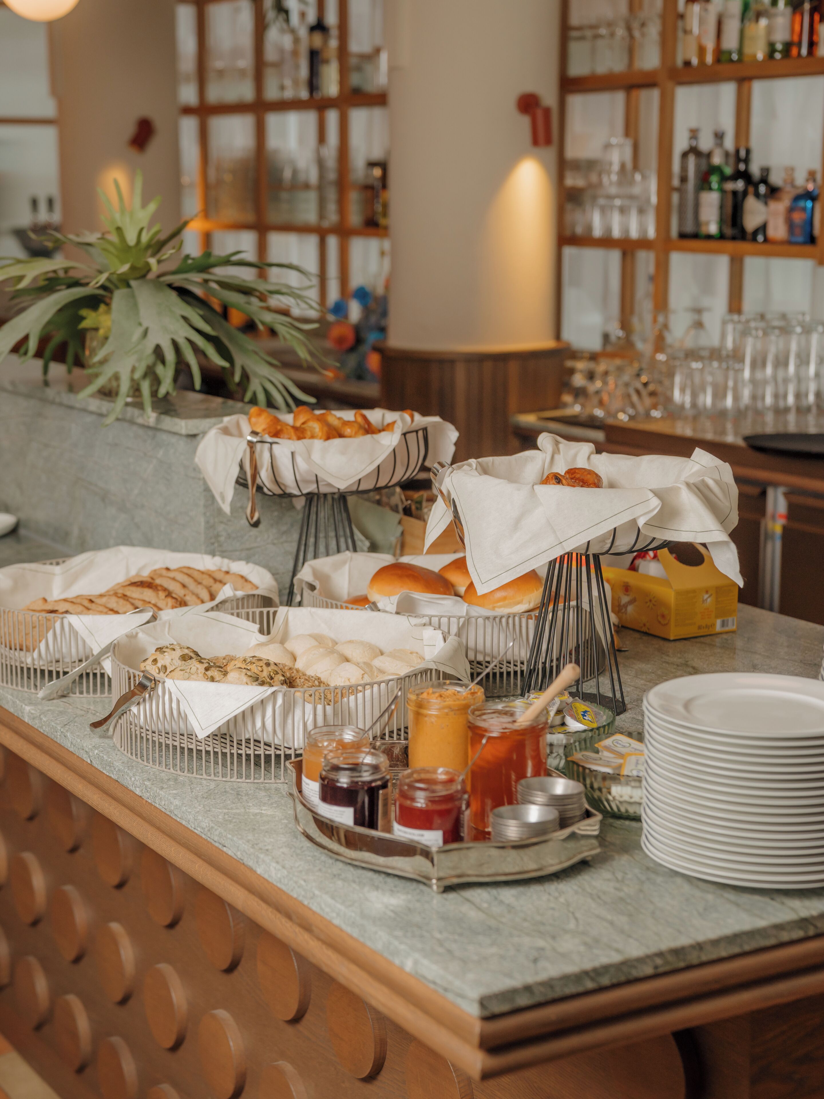 A buffet setup with various food items and condiments.